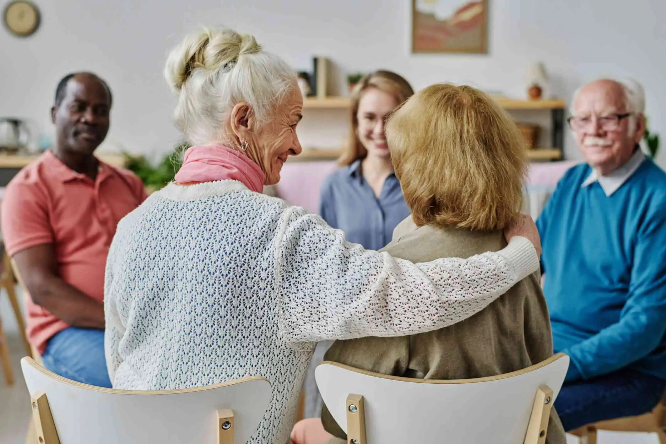 Care residents and a care professional in a group session